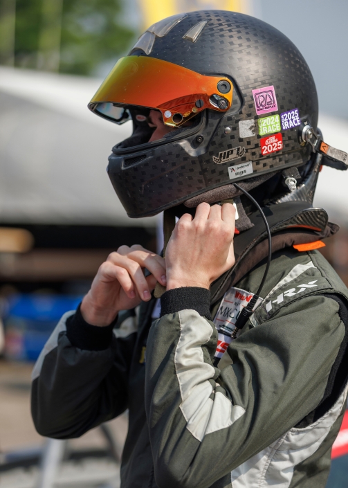 Vaughn Mishko puts on racing helmet